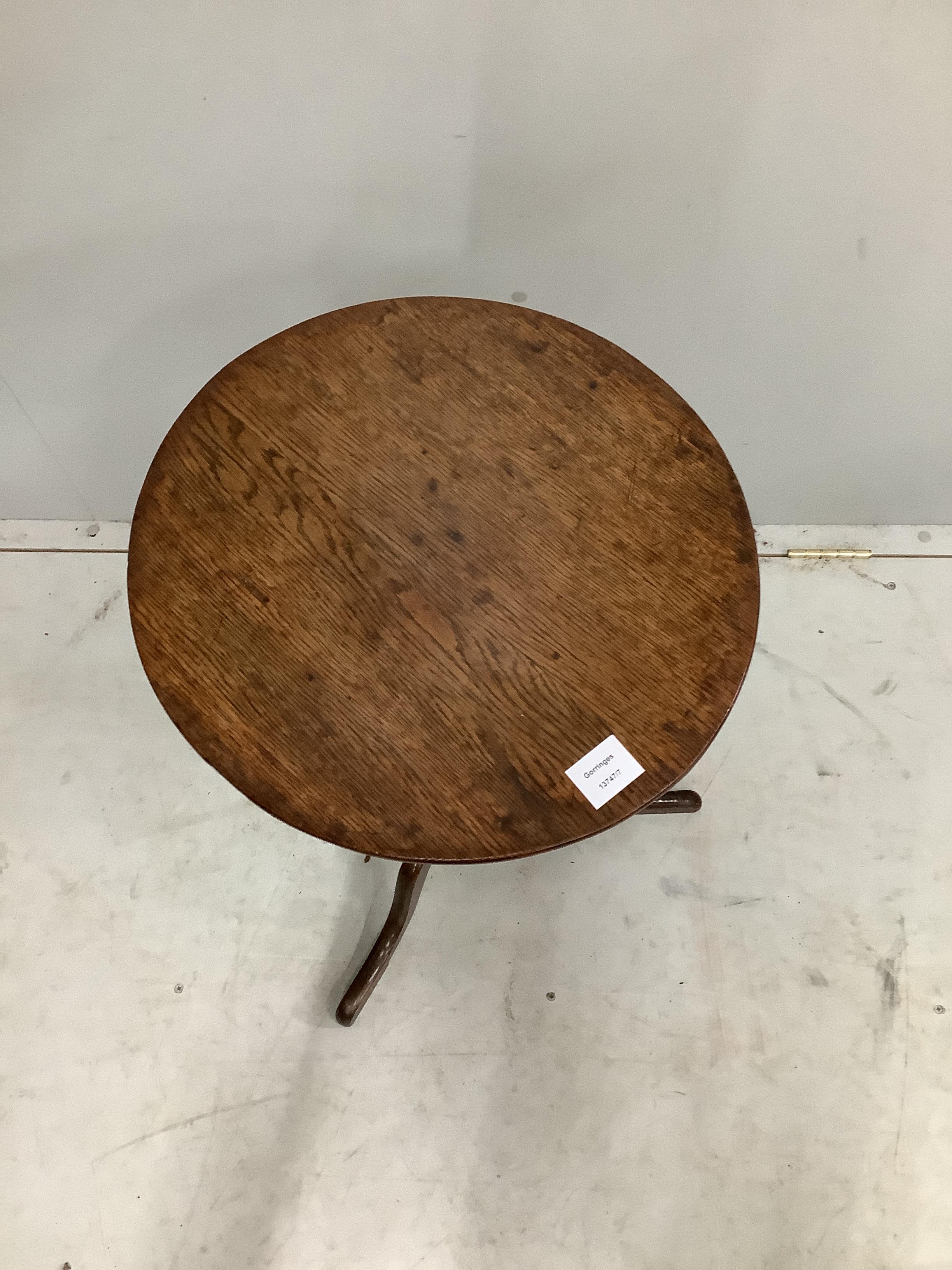 A George III circular oak tripod wine table, diameter 43cm, height 68cm